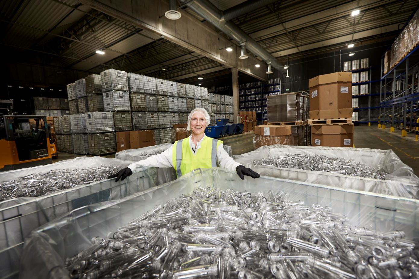 Sølvy Aslaksen, emballasjeekspert i Ringnes - sammen med preformer som blåses opp til brusflasker.